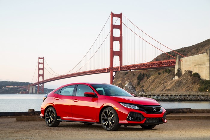 Red 2017 Honda Civic Touring Hatchback near Golden Gate Bridge