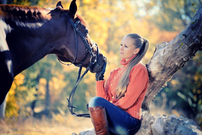 Girl in orange sweater with horse