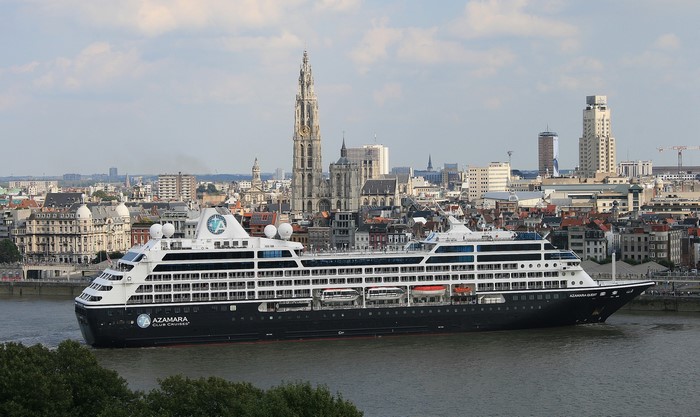 Azamara Quest cruise ship sailing past Antwerp skyline