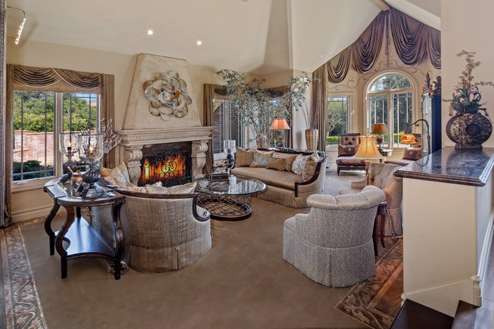 Living room with fireplace, sofa, and armchairs