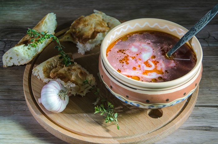 Soup with Bread and Garlic on Cutting Board