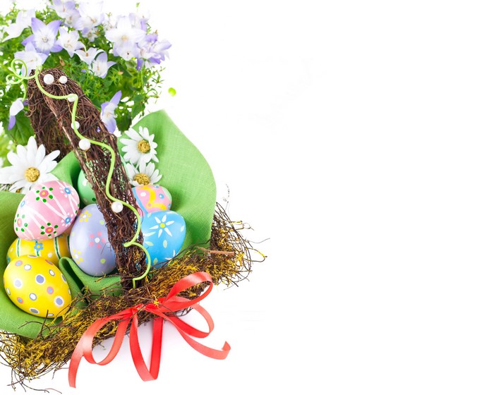 Easter basket with decorated eggs and flowers