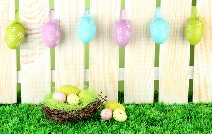 Easter eggs on a wooden fence and grass