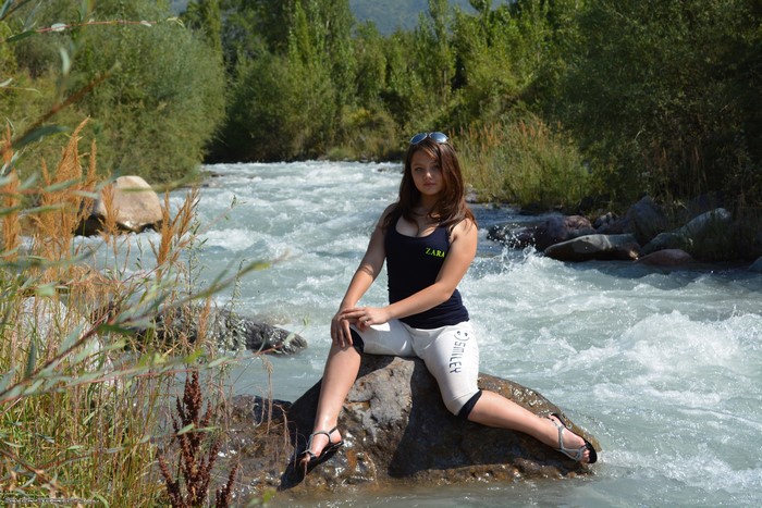 Girl Sitting on Stone by the River