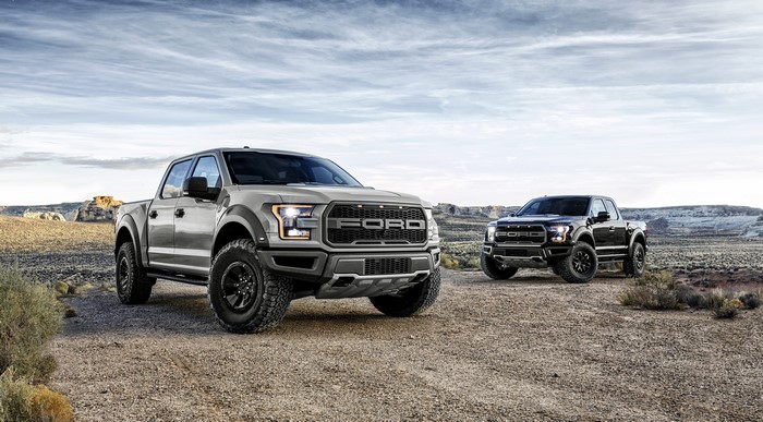 Two Ford F-150 Raptor Pickup Trucks in Desert