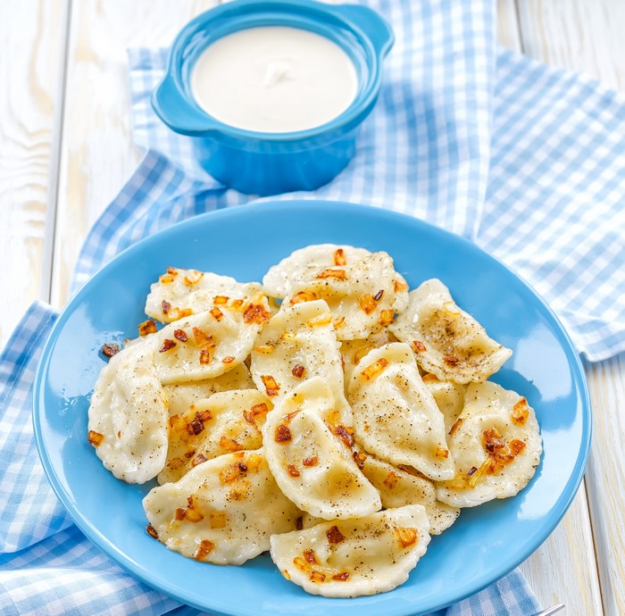 Pierogi with fried onions and sour cream