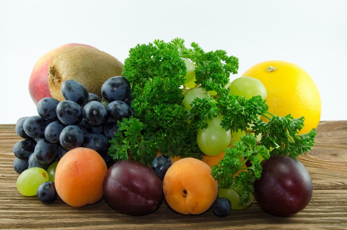 4K Fruit Plums Peaches Grapes on Wood Planks