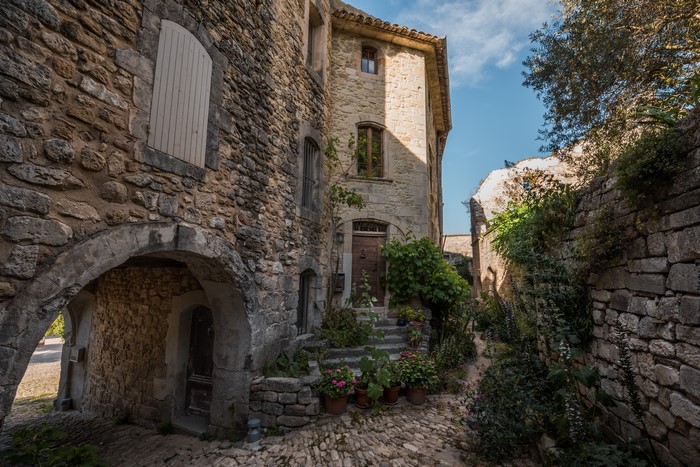 Stone houses and cobblestone street in Oppede, Provence, France