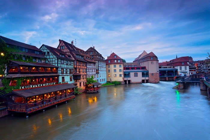Strasbourg, France riverfront buildings at dusk
