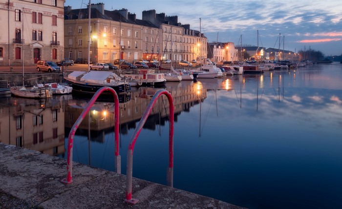 Boats docked in a marina at dusk in Redon, France