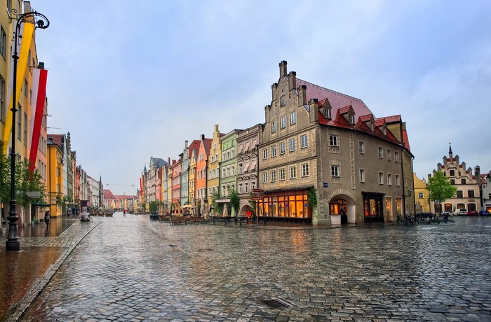 Rainy evening in a European town square with colorful buildings