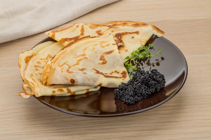 Pancakes with Caviar and Garnish on a Plate