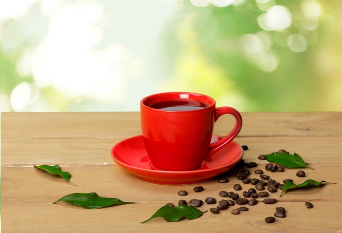 4K Red Coffee Cup with Coffee Beans and Green Leaves