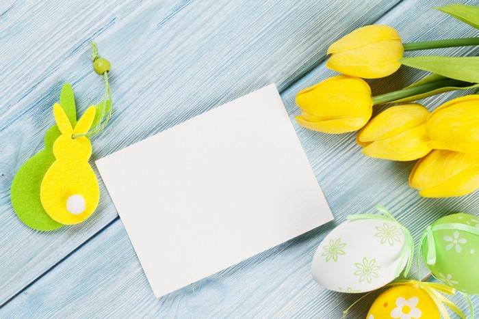 Easter greeting card with tulips and eggs on wood