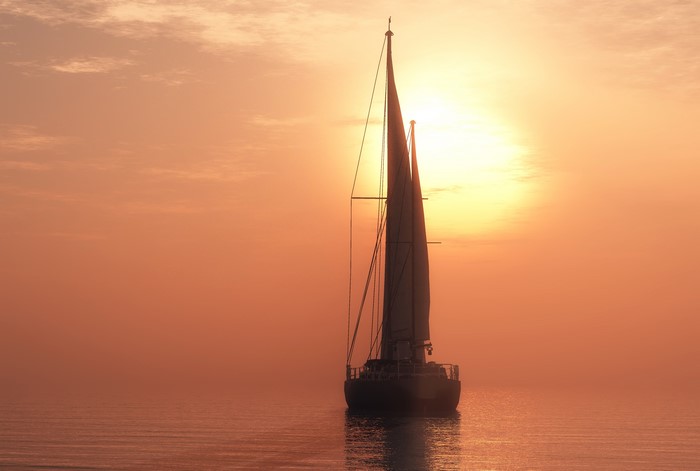 Sailboat on the sea at sunset