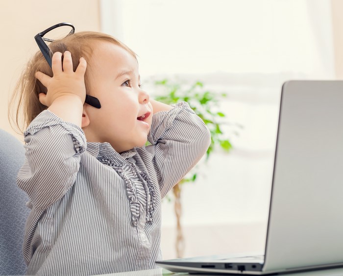 Baby with glasses and laptop