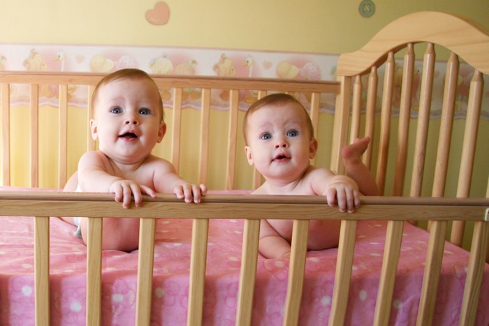 Two babies in a crib