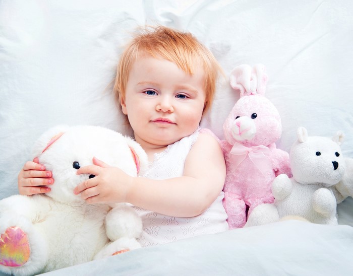 Baby girl with teddy bears and toys