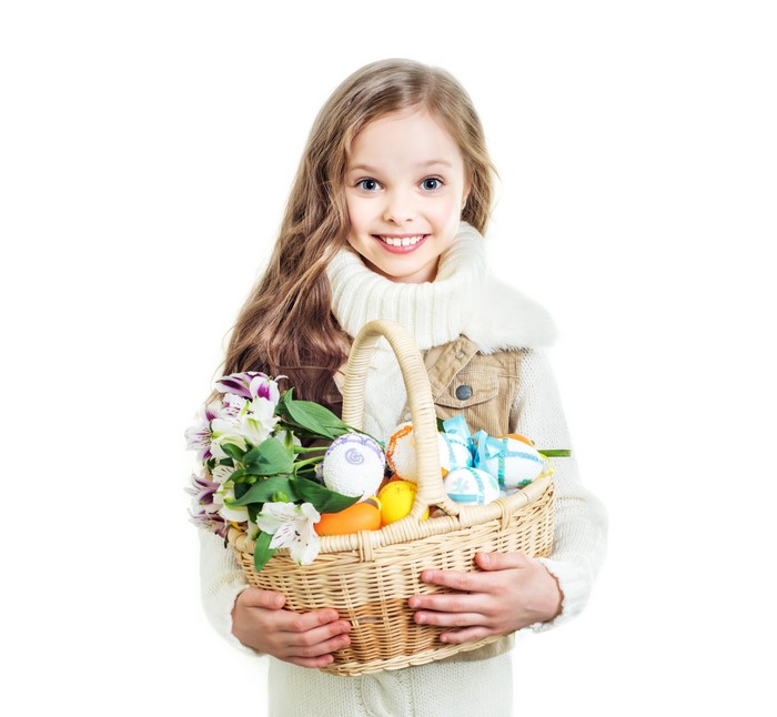 Girl holding Easter basket with flowers and eggs