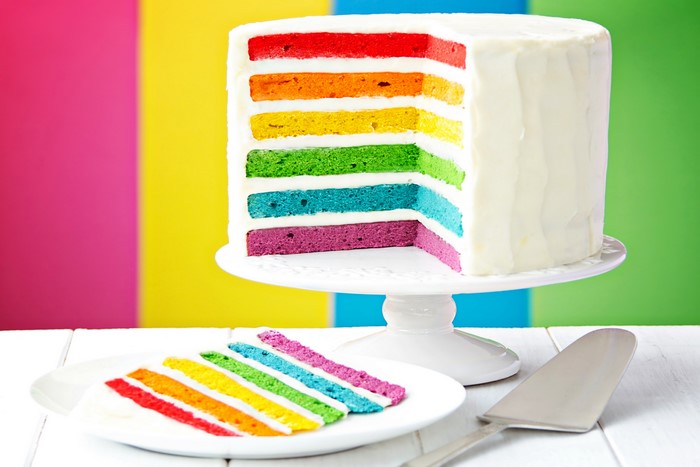 Rainbow Layer Cake with Slice on Plate