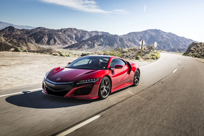 Red 2017 Acura NSX driving on a desert road