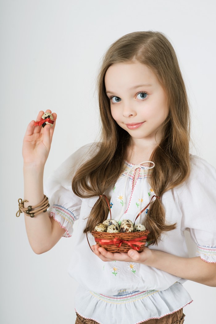 Girl holding Easter eggs in a basket