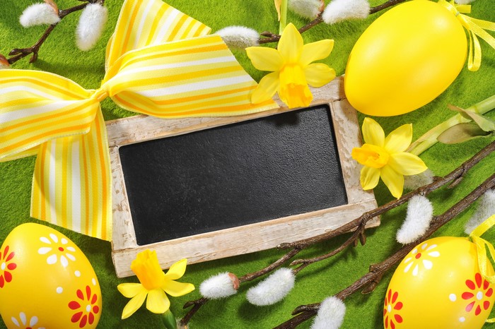 Easter greeting card with eggs, daffodils, and chalkboard