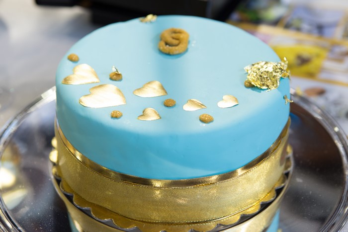 Blue cake with gold hearts and ribbon