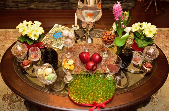 Haft-Seen table with wine, apples, eggs, and flowers