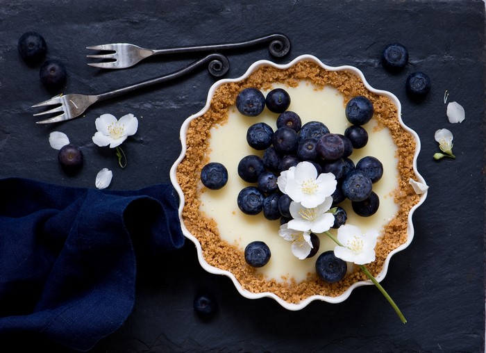 Blueberry Pie with White Flowers and Forks