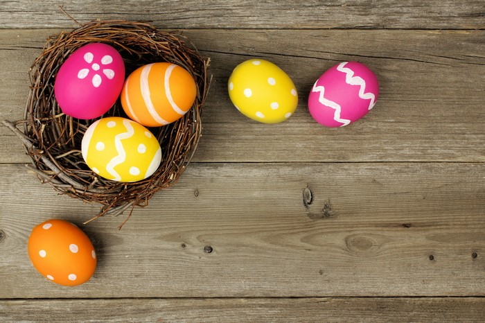 Easter eggs in a nest on wood planks