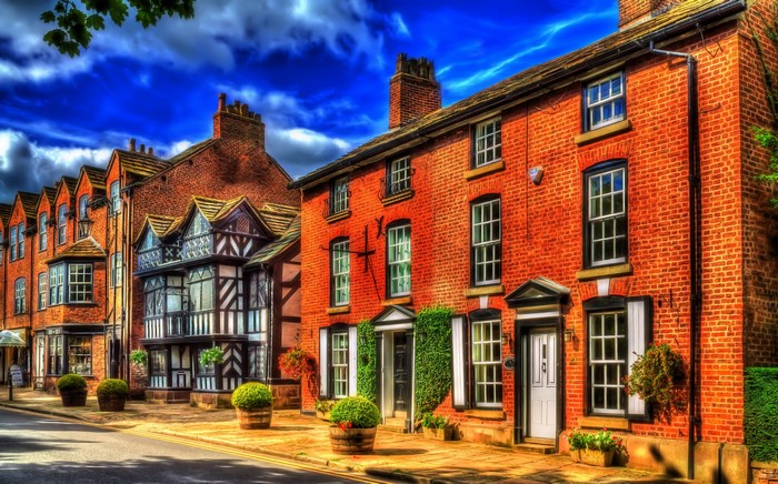 Row of historic brick and timber-framed houses in Prestbury, England