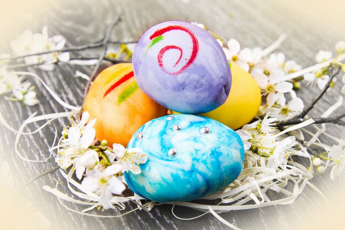 Easter Eggs with Blossoms on Wooden Surface