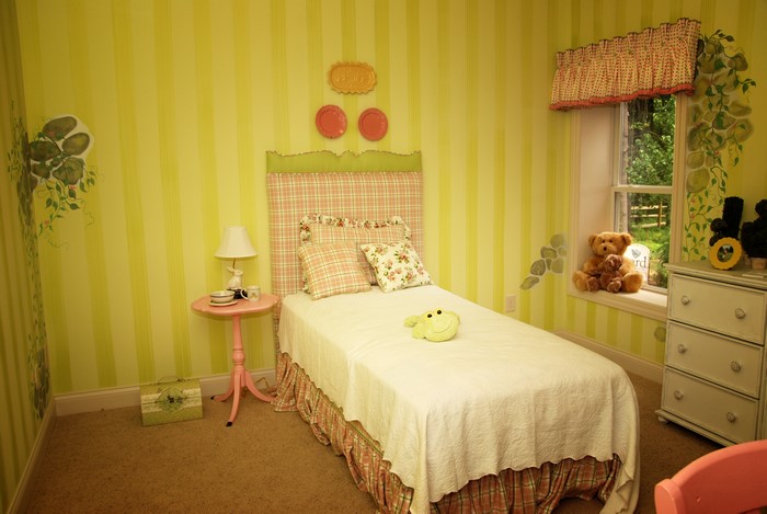 Children's bedroom with bed, lamp, and toys