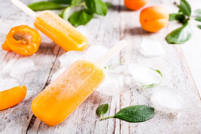 Orange popsicles with apricots and ice