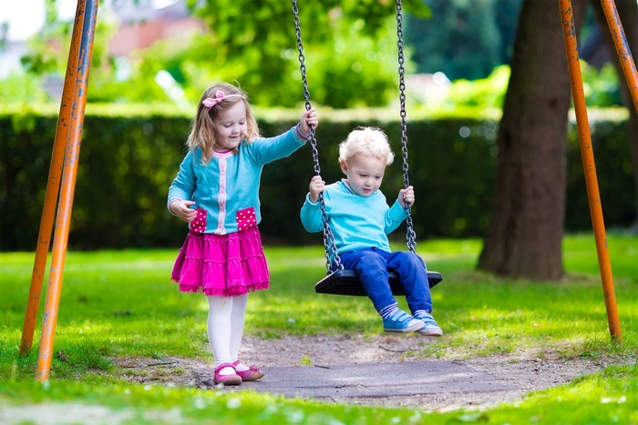 Children on a swing set in a park