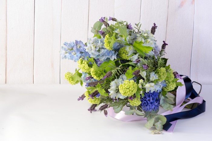 Bouquet of blue and green flowers with lavender and ribbons