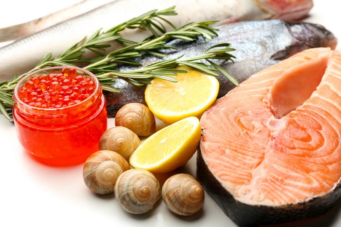 Seafood platter with salmon, caviar, lemons, and snails