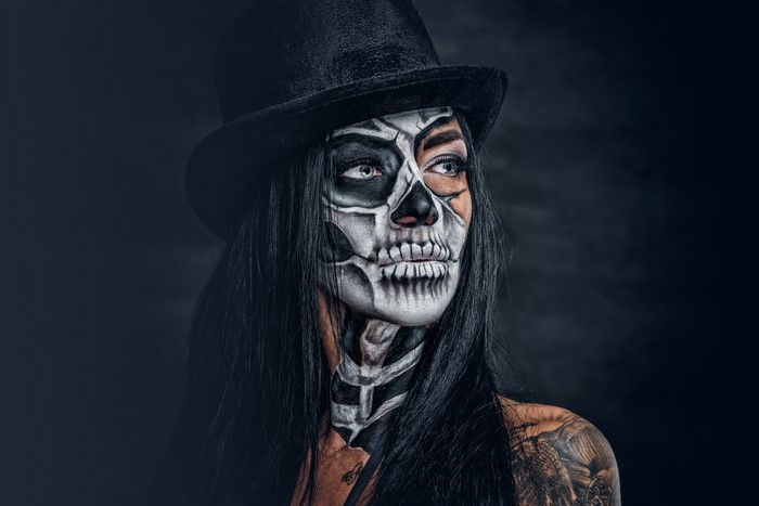 Woman with Day of the Dead makeup and top hat