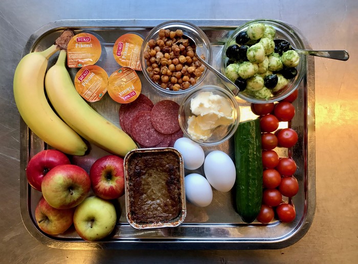 Breakfast tray with fruits, eggs, and charcuterie