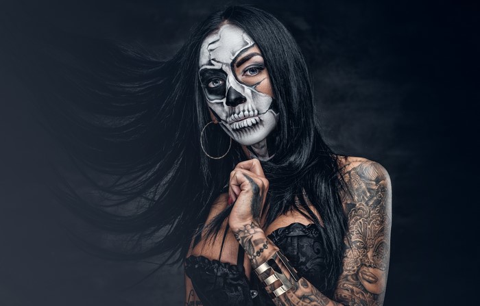 Woman with Day of the Dead makeup and tattoos