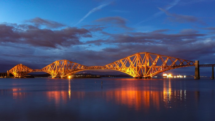 Forth Rail Bridge at night over water