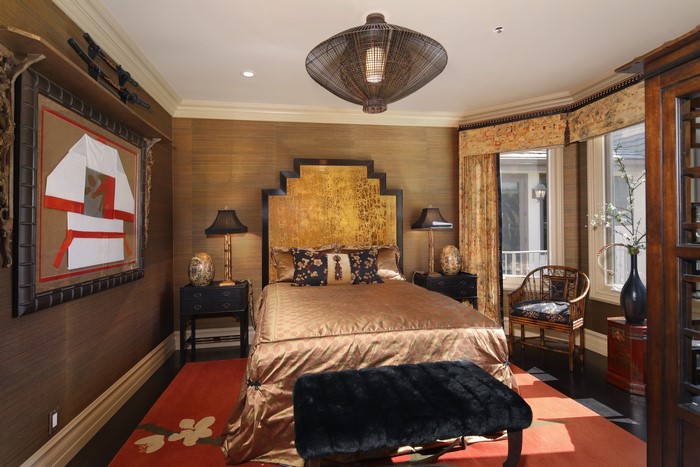 Bedroom with Asian-inspired decor and a large chandelier