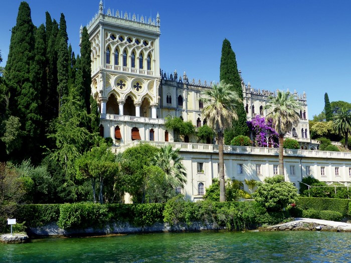 Villa on a lake with cypress trees and palm trees