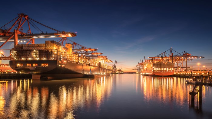 Container ships and cranes at Hamburg harbour at night