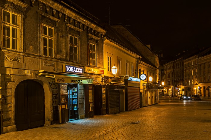 Street at night with tobacco shop and clock in Zagreb, Croatia