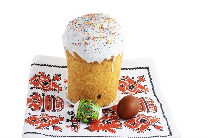 Easter Kulich with Icing and Eggs on Embroidered Cloth
