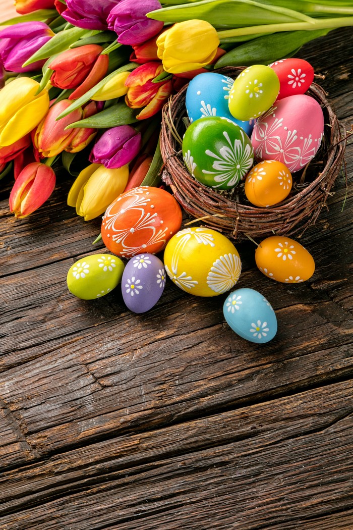 Easter Tulips and Decorated Eggs on Wooden Table