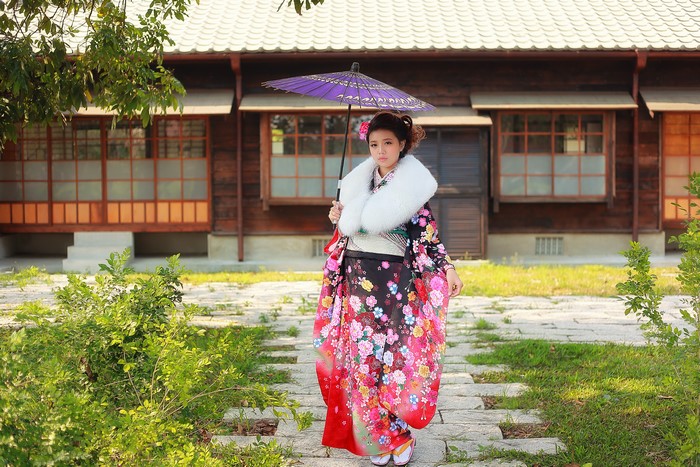 Woman in Kimono holding an Umbrella