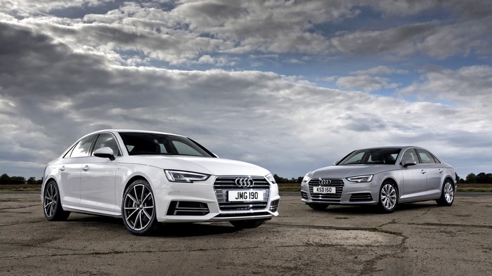 Two Audi Sedans on a Cloudy Day